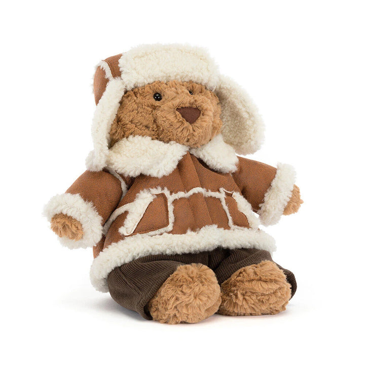 Jellycat Bartholomew Bear Alpine teddy bear in a cozy winter outfit with ear flaps