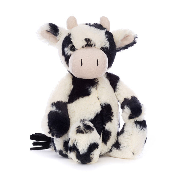Jellycat Bashful Calf Original medium plush toy showcasing its signature splotchy black and white fur, floppy ears, and soft cream horns.