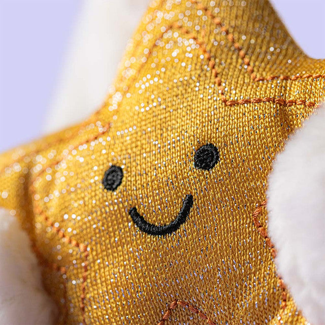 Close-up of the Jellycat Cream Bunny showing the textured golden star and signature long ears