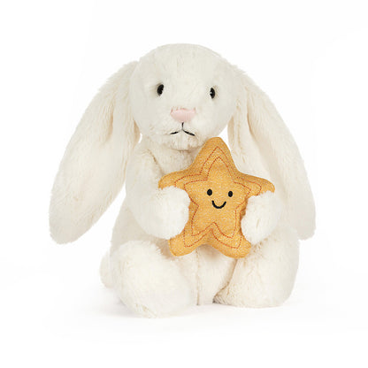 Jellycat Bashful Cream Bunny holding a plush golden star with a soft, smiling face.