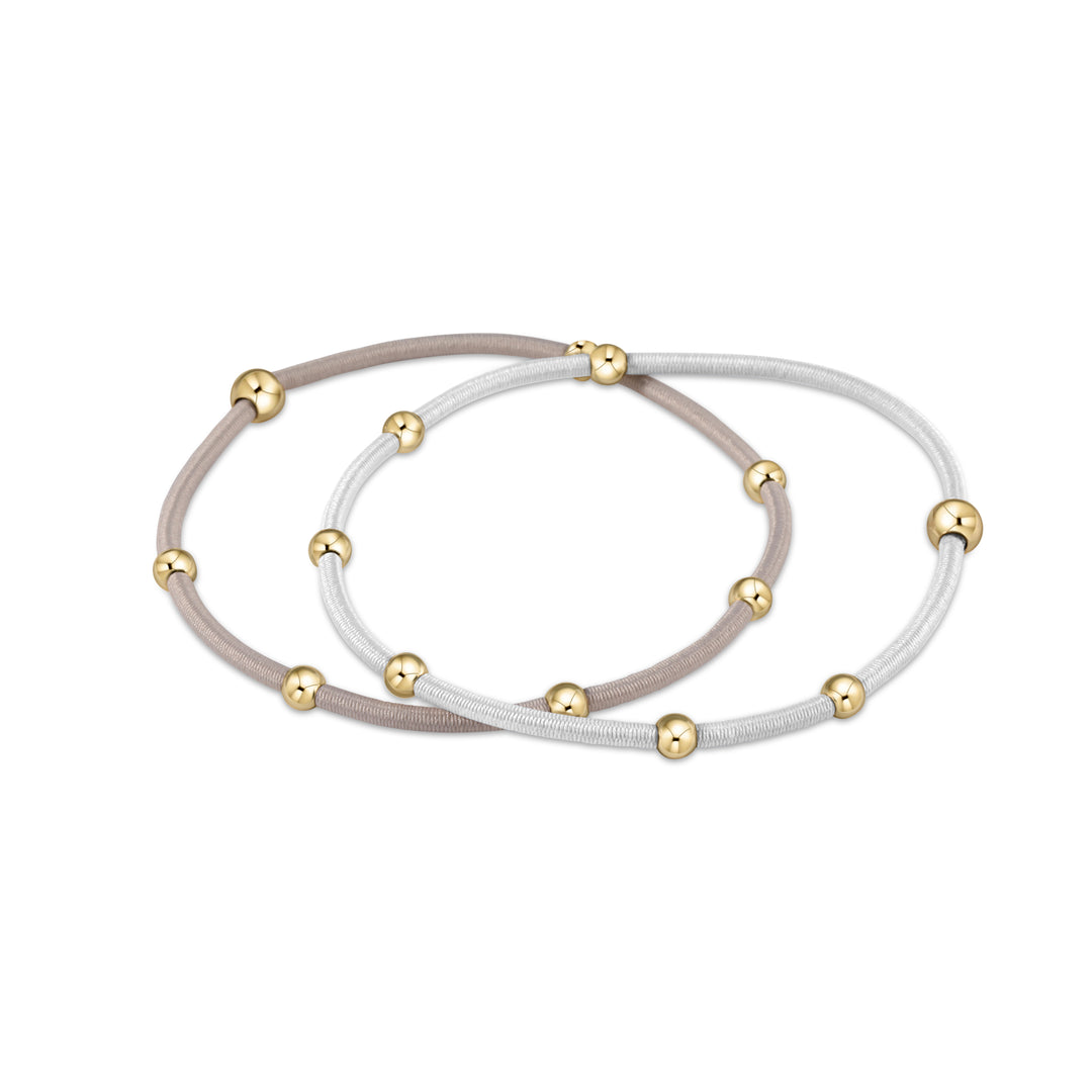 A pack of two enewton essentials Dove grey elastic bracelets accented with tarnish-free 14kt gold-filled beads used as functional hair ties.