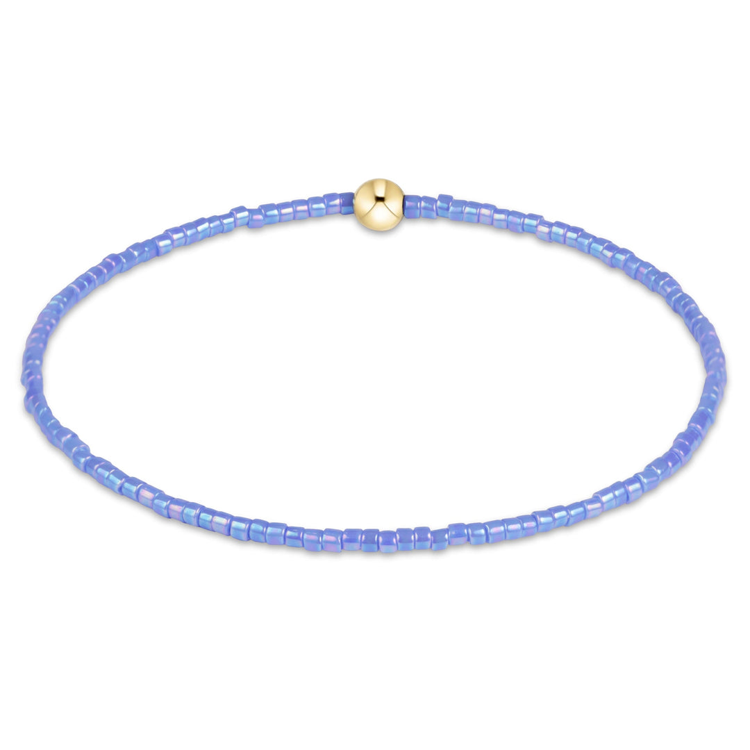 enewton Hope Classic bracelet in bright blue seed beads with a gold accent bead, shown on the wrist