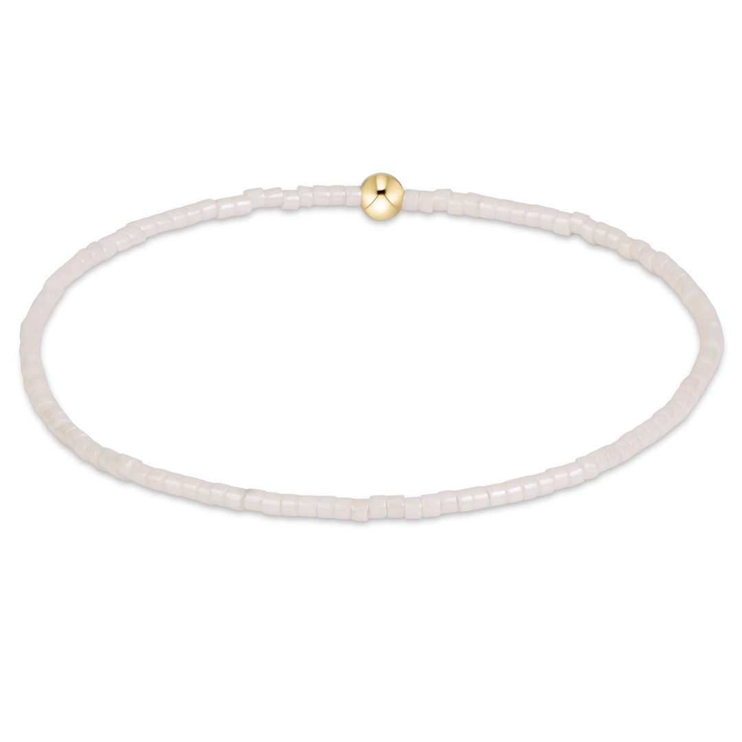 enewton Hope Classic bracelet in Milkshake neutral seed beads with a gold accent bead, shown on the wrist