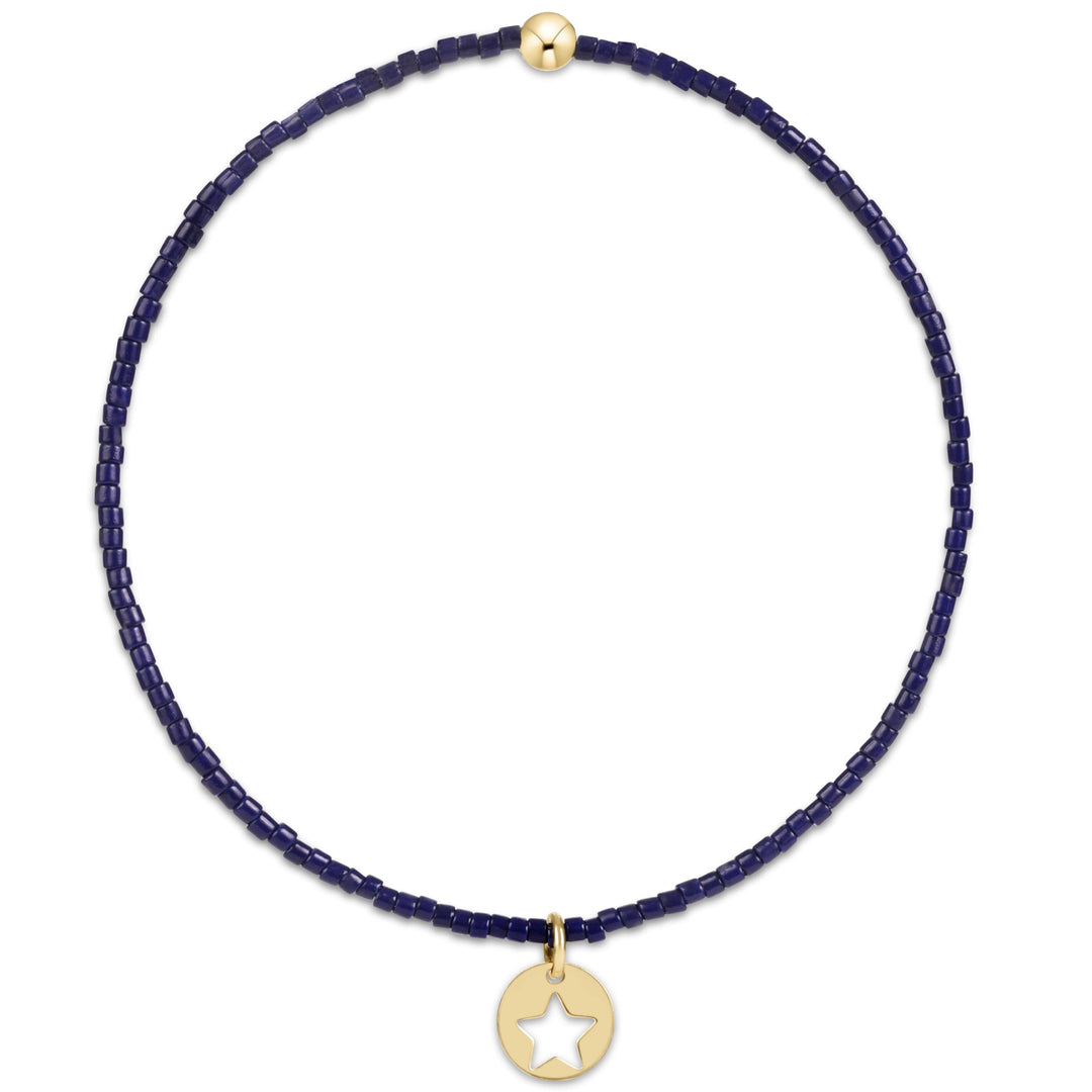 enewton design Hope Classic Bracelet in Navy highlighting its hand-beaded design, 14k gold-filled details, and delicate star disc charm.