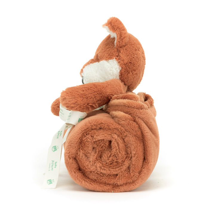 Jellycat Bashful Fox Cub Blankie neatly rolled and tied with a ribbon, featuring a soft plush fox head and terracotta ears.