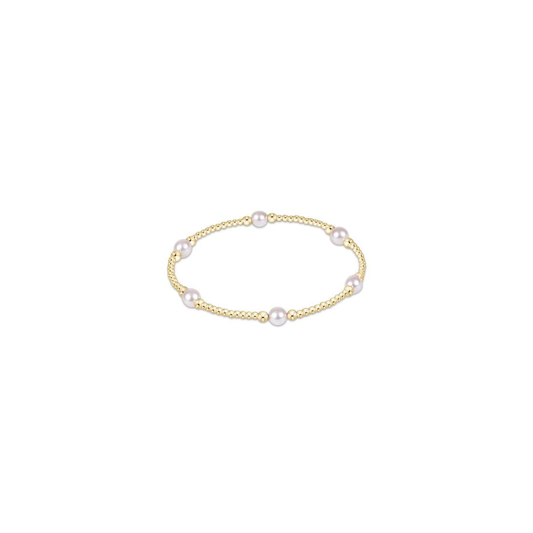 An enewton Purpose Pearl 5mm gold bead bracelet featuring alternating 14kt gold-filled beads and natural freshwater rice pearls on a stretch elastic cord.