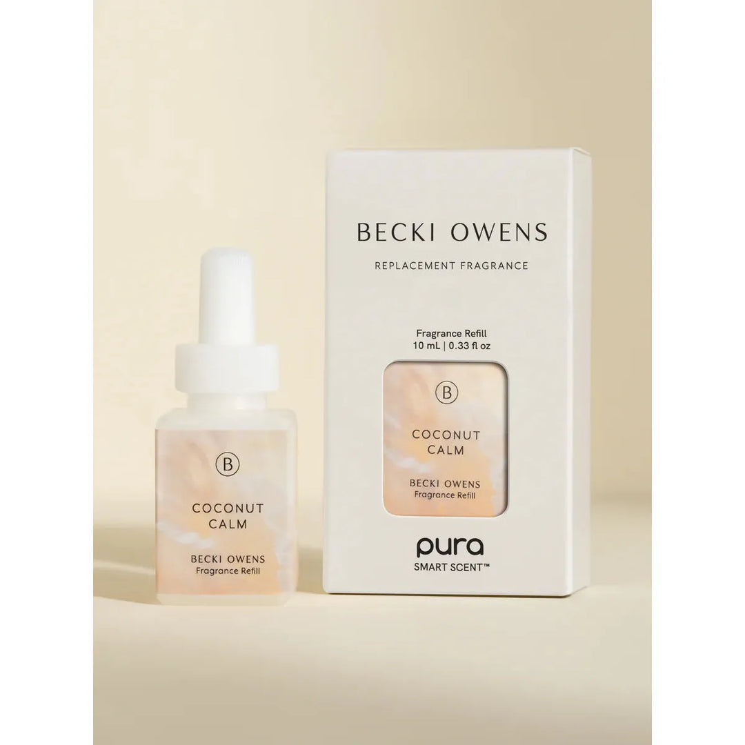 Pura smart fragrance vial in Coconut Calm by Becki Owens, featuring a minimalist white label with floral and coconut sketches.