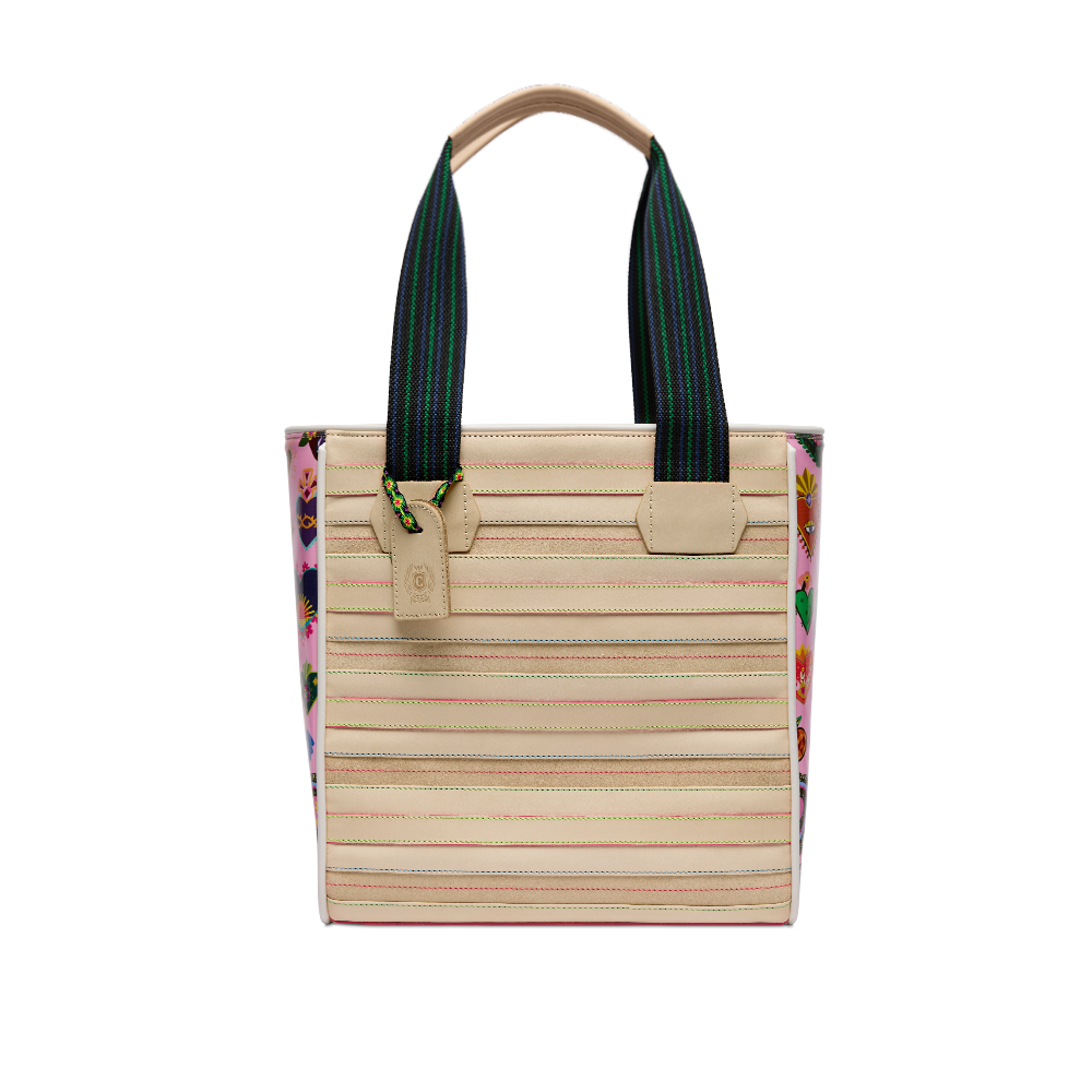 Consuela Caroline Classic Tote, front view of the cream stitched body with pink heart-print sides and woven straps on a light background.