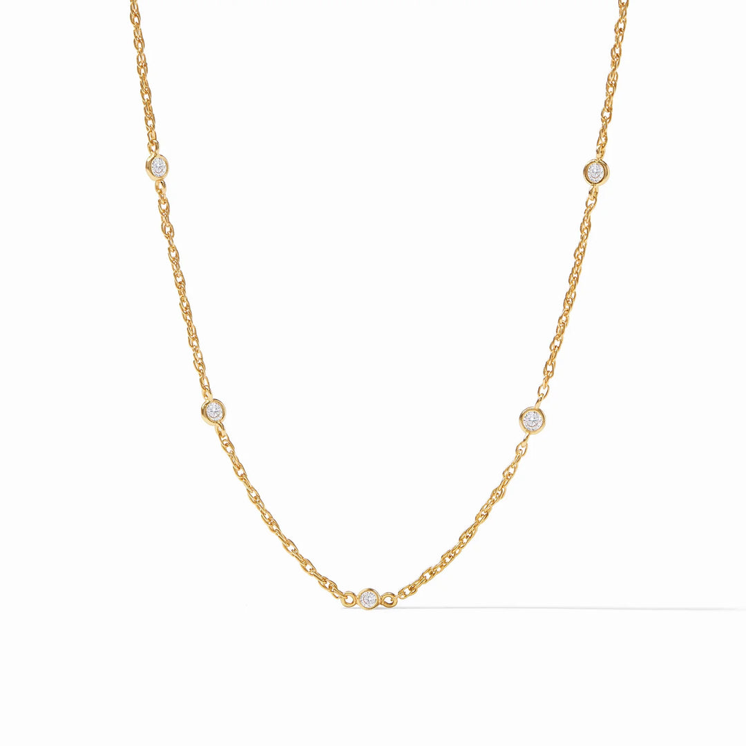 A delicate gold necklace with cubic zirconia accents, displayed against a white background.