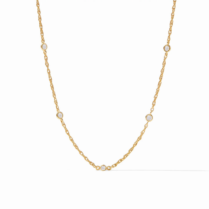 A delicate gold necklace with cubic zirconia accents, displayed against a white background.