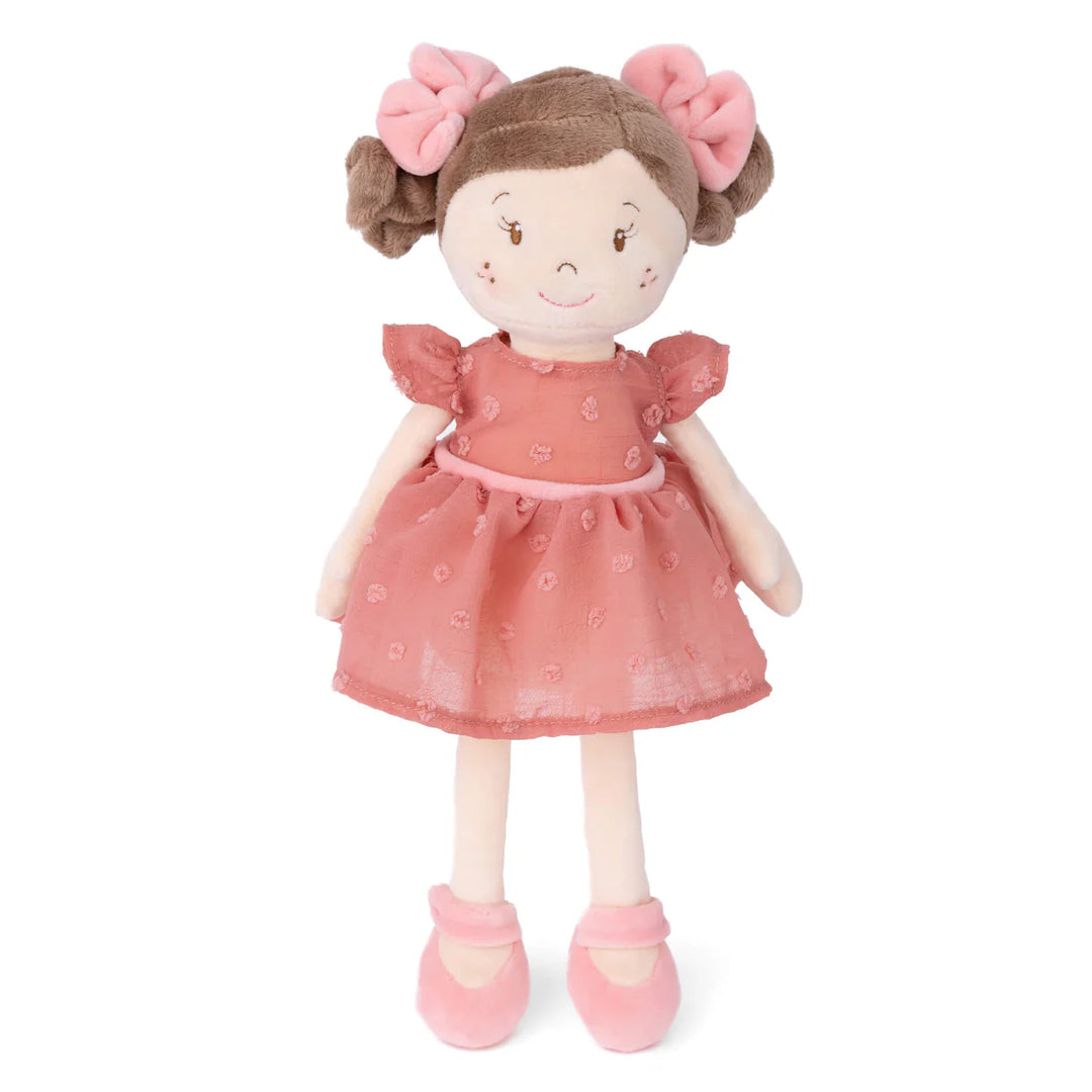 12-inch plush doll named Clara with brown pigtails wearing a pink dress and white shoes.