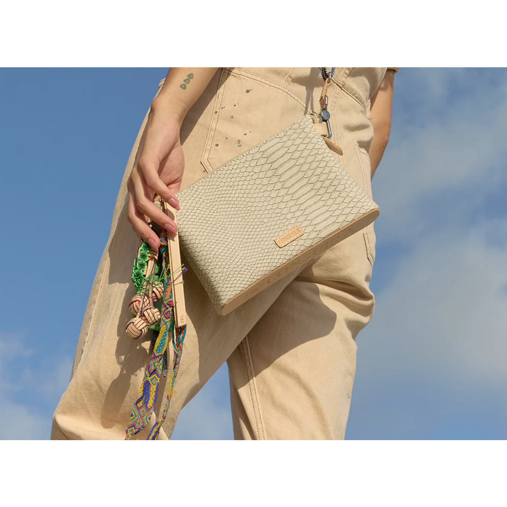 Consuela Thunderbird Midtown Crossbody featuring an embossed snake print exterior and colorful signature charms.