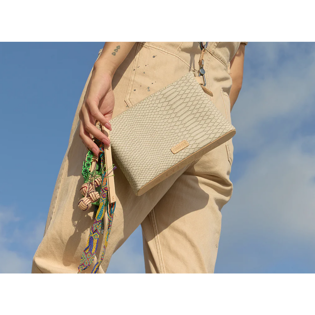 Consuela Thunderbird Midtown Crossbody featuring an embossed snake print exterior and colorful signature charms.