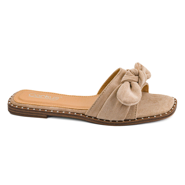 Corkys Clam Bake casual flat shoe in sand faux suede showcasing its minimal slip-on silhouette and clean neutral stitch detailing.