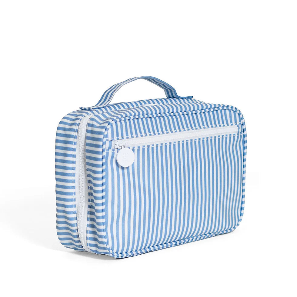 Blue and white striped hanging toiletry bag by TRVL Design with white chunky zippers and multiple clear/mesh interior pockets.