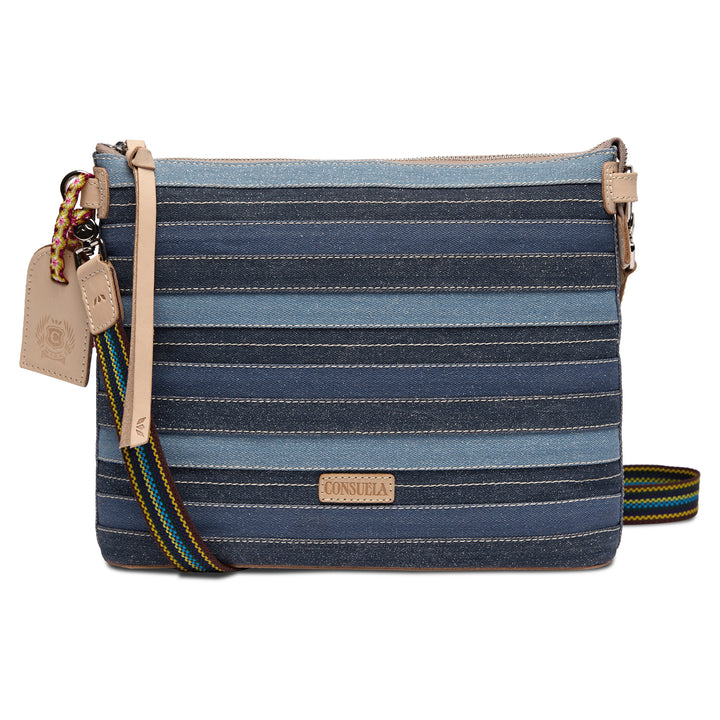 Consuela Royal Downtown Crossbody in denim-inspired blue stripes, front view with natural leather accents, a woven strap, and a Consuela hangtag.