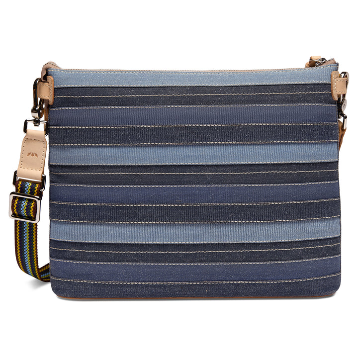Back view of the Consuela Royal Downtown Crossbody in denim stripes with an adjustable woven strap and silver hardware.