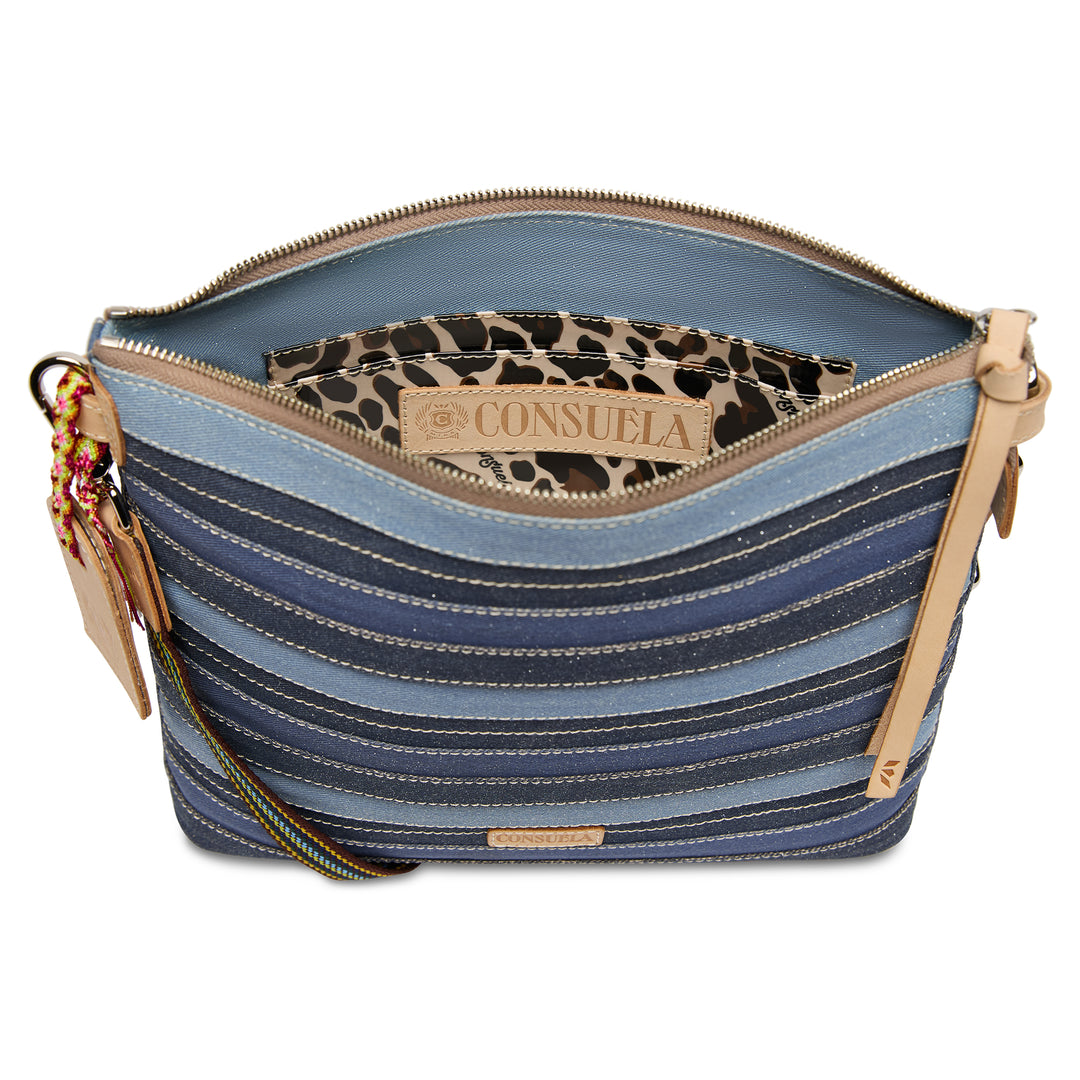 Interior view of the Consuela Royal Downtown Crossbody with a leopard-print lining, slip pocket, and Consuela-branded leather patch.