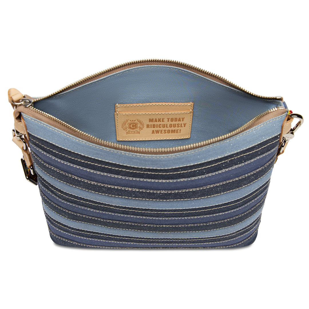 Open-top view of the Consuela Royal Downtown Crossbody with an interior leather card pocket stamped Make Today Ridiculously Awesome.