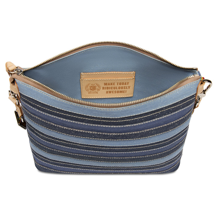 Open-top view of the Consuela Royal Downtown Crossbody with an interior leather card pocket stamped Make Today Ridiculously Awesome.