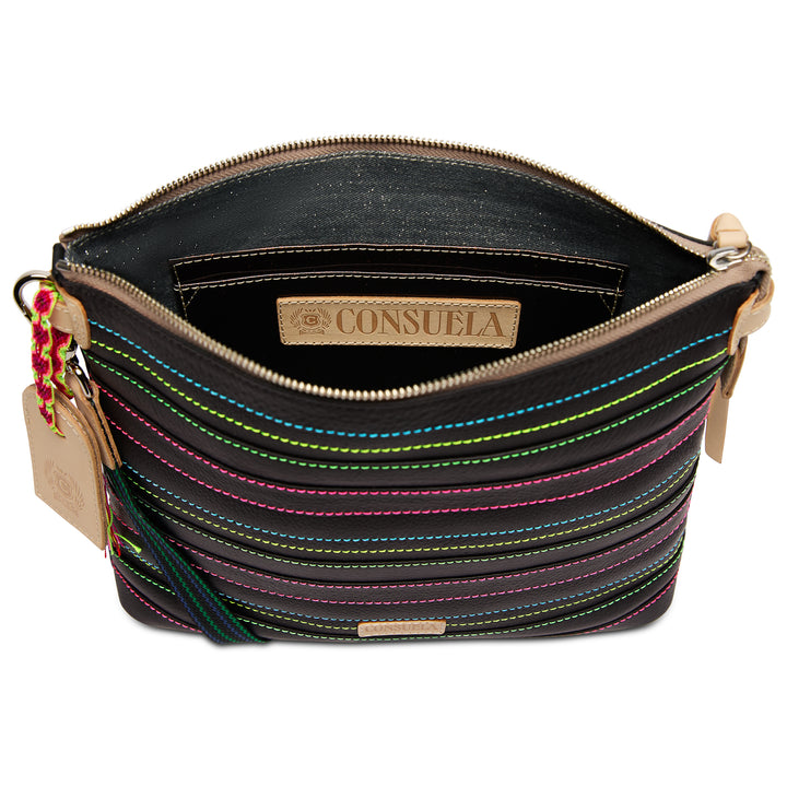 Interior view of the Consuela Ray Downtown Crossbody with a denim-look lining, slip pocket, and Consuela-branded leather patch.