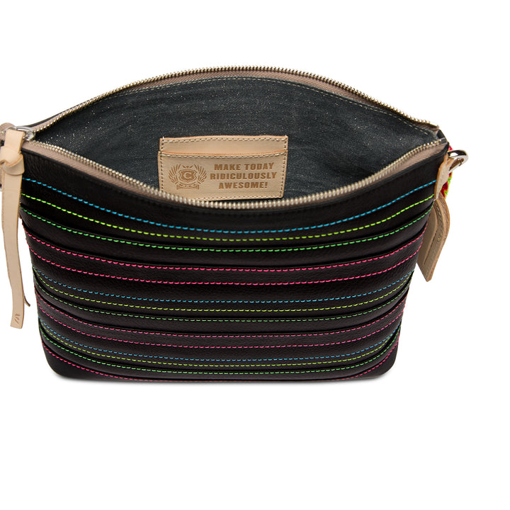 Open-top view of the Consuela Ray Downtown Crossbody with an interior leather card pocket stamped Make Today Ridiculously Awesome.