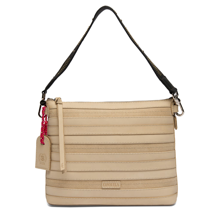 Consuela Amina Downtown Crossbody in natural cream ribbed leather, front view with a studded leather shoulder strap and a Consuela hangtag.