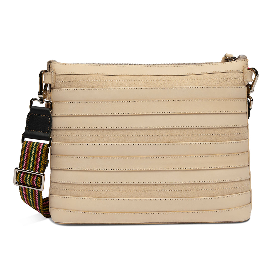 Back view of the Consuela Amina Downtown Crossbody showing the ribbed natural leather and adjustable rainbow strap with silver hardware.