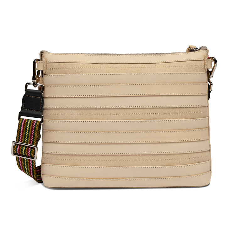 Back view of the Consuela Amina Downtown Crossbody showing the ribbed natural leather and adjustable rainbow strap with silver hardware.