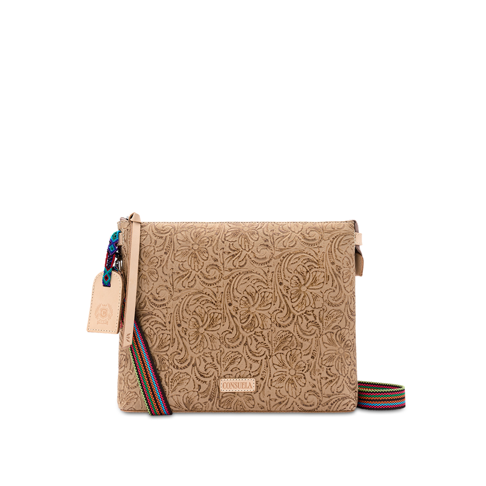 Consuela Lawton Downtown Crossbody, front view of the embossed floral leather bag with an adjustable multi-color woven crossbody strap.
