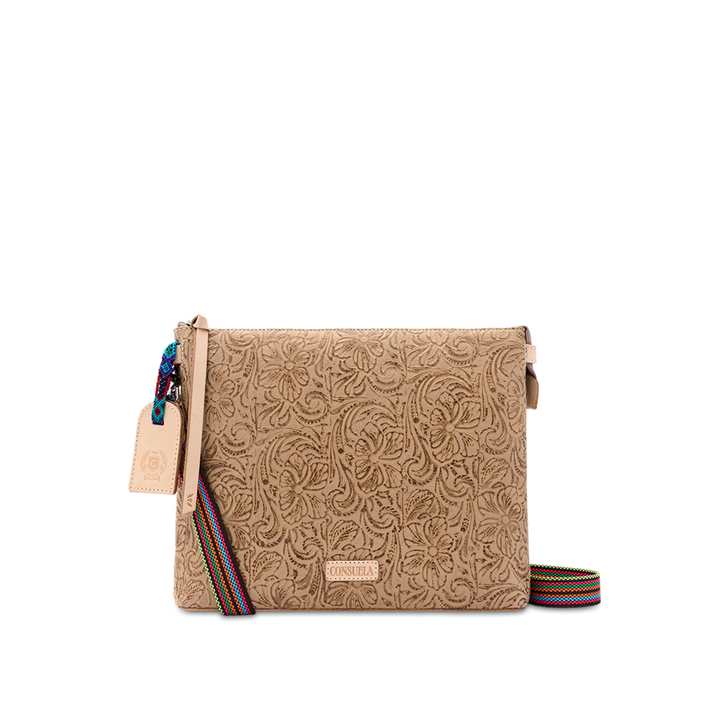 Consuela Lawton Downtown Crossbody, front view of the embossed floral leather bag with an adjustable multi-color woven crossbody strap.