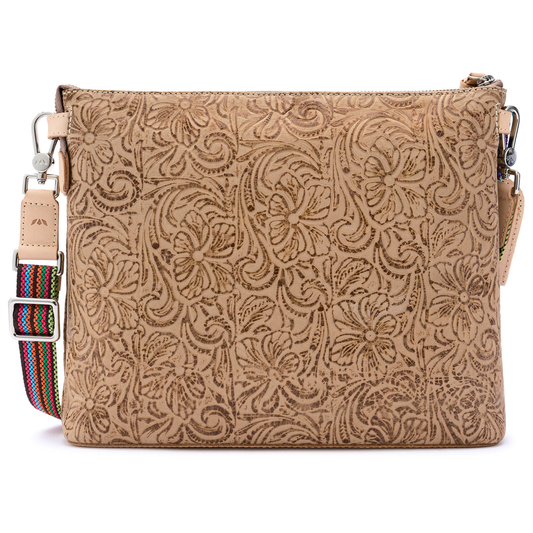 Back view of the Consuela Lawton Downtown Crossbody showing the embossed floral leather and adjustable woven strap with silver hardware.