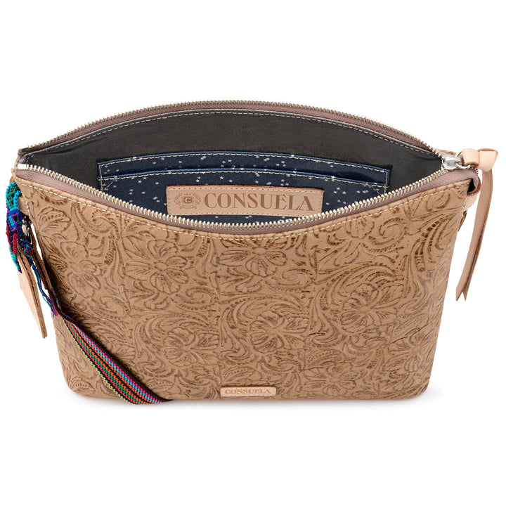 Interior view of the Consuela Lawton Downtown Crossbody showing the lined main compartment, a slip pocket, and the Consuela-branded leather patch.