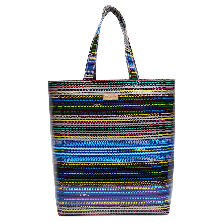 Consuela Hadley Basic Bag with horizontal colorful stripes, natural leather logo, and open top for utility use.