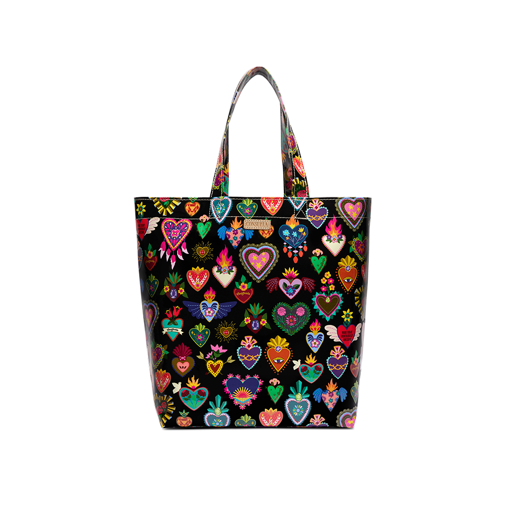 Consuela Vida Grab n Go Basic tote in glossy black, covered front-on with a colorful Mexican folk-art sacred-heart print, tall top handles, and a Consuela leather logo tab.