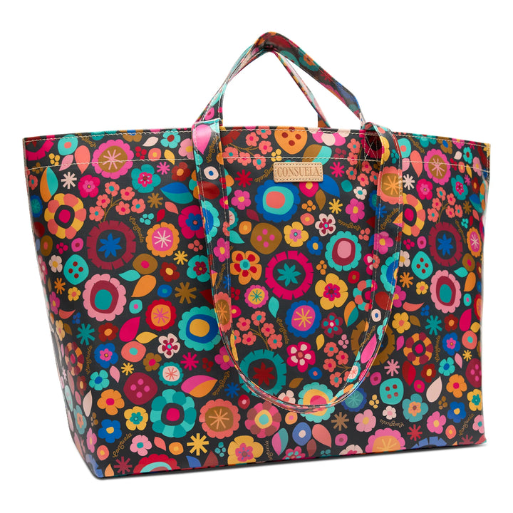 Close-up of the Amelie floral ConsuelaCloth pattern and the Diego natural leather logo accent.