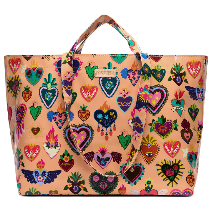 Front view of the Consuela Peach Grab n Go Jumbo tote showing its wide body, peach base, vibrant corazon heart print, and a Consuela leather logo tab.