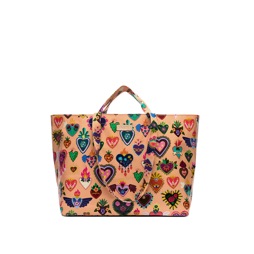 Consuela Peach Grab n Go Jumbo tote standing upright with an open, roomy top, glossy peach exterior, and colorful sacred-heart designs.