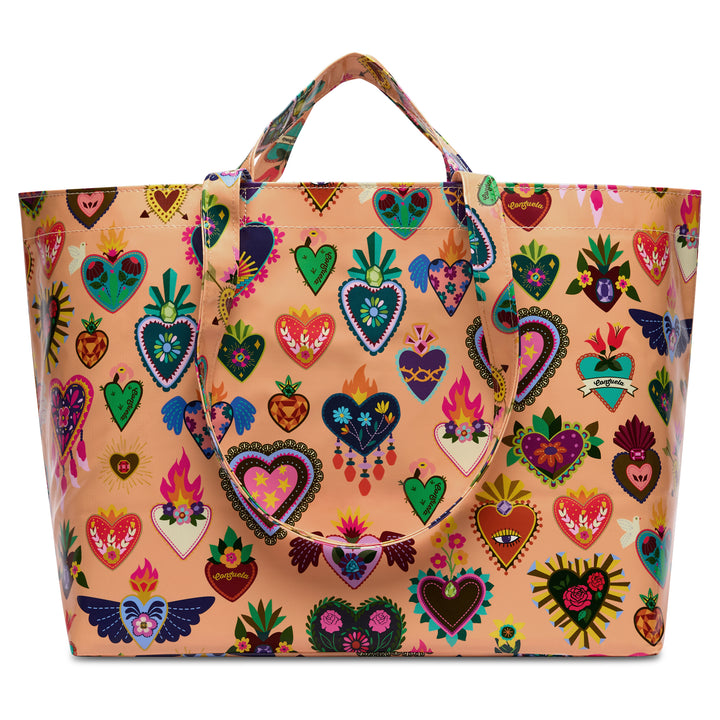 Consuela Peach Grab n Go Jumbo oversized tote in glossy peach, front view covered with a colorful folk-art sacred-heart and floral print and dual top handles.