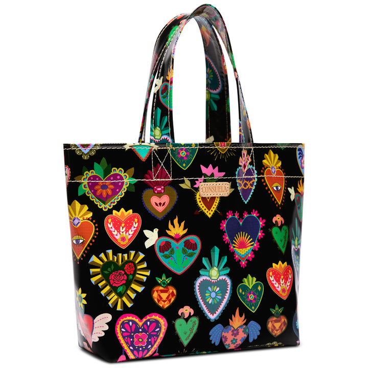Consuela Vida Grab n Go Basic tote in glossy black, covered front-on with a colorful Mexican folk-art sacred-heart print, tall top handles, and a Consuela leather logo tab.