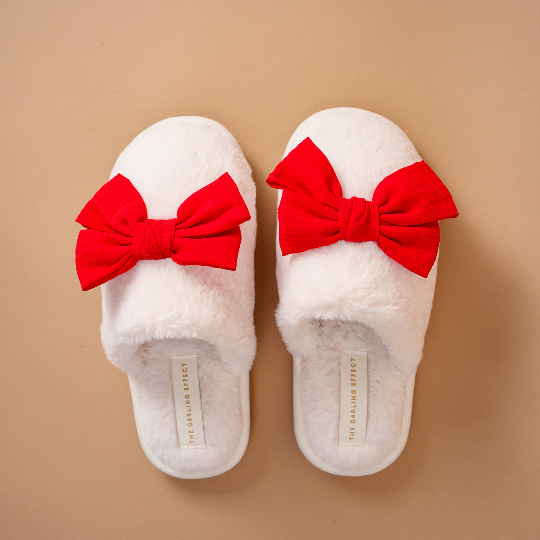 Pair of plush red The Darling Effect On Cloud Nine Slippers featuring a sweet bow detail.