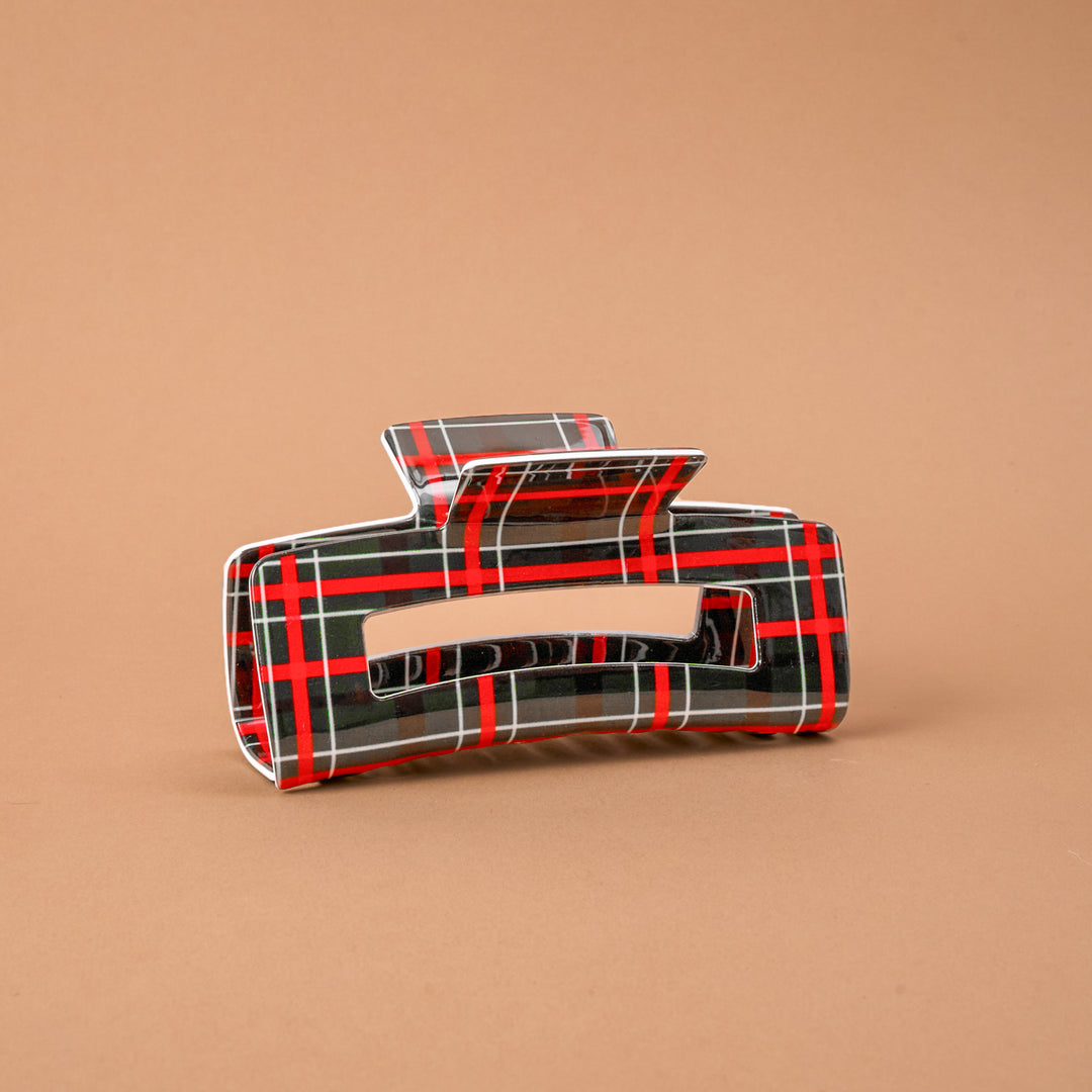 The Darling Effect rectangular hair claw clip in a festive red and green Evergreen Plaid pattern.