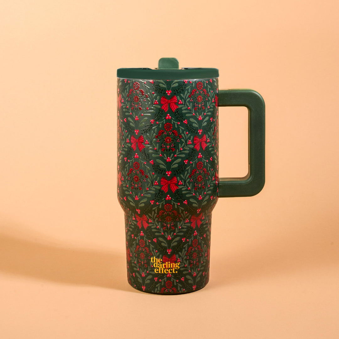 The Darling Effect 20 oz Lifestyle Flip Straw Tumbler featuring the festive green and red A Merry Moment floral holiday print.