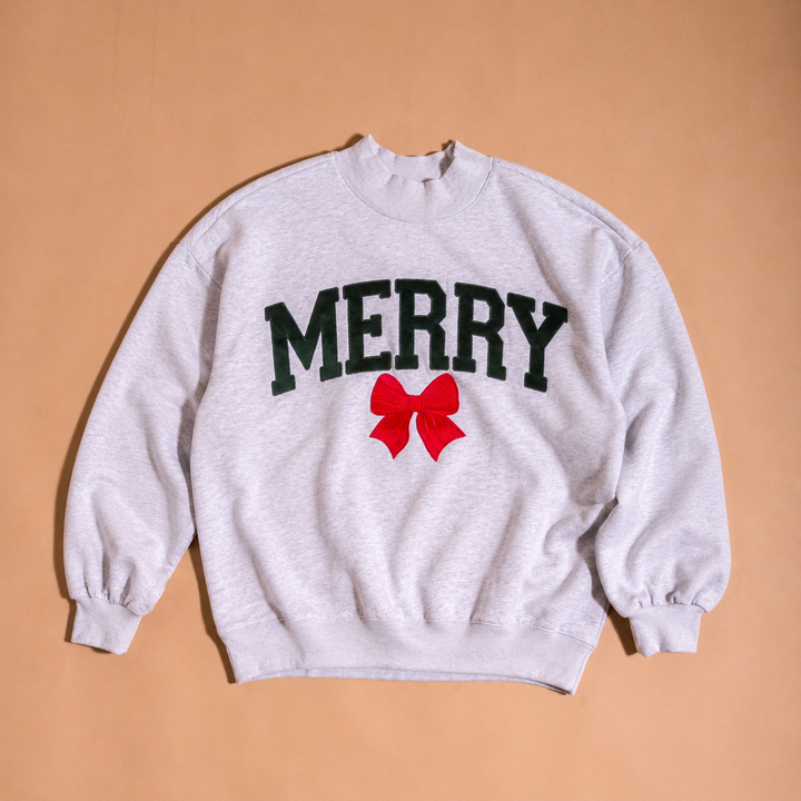 The Darling Effect Merry Bow mockneck Christmas sweatshirt.