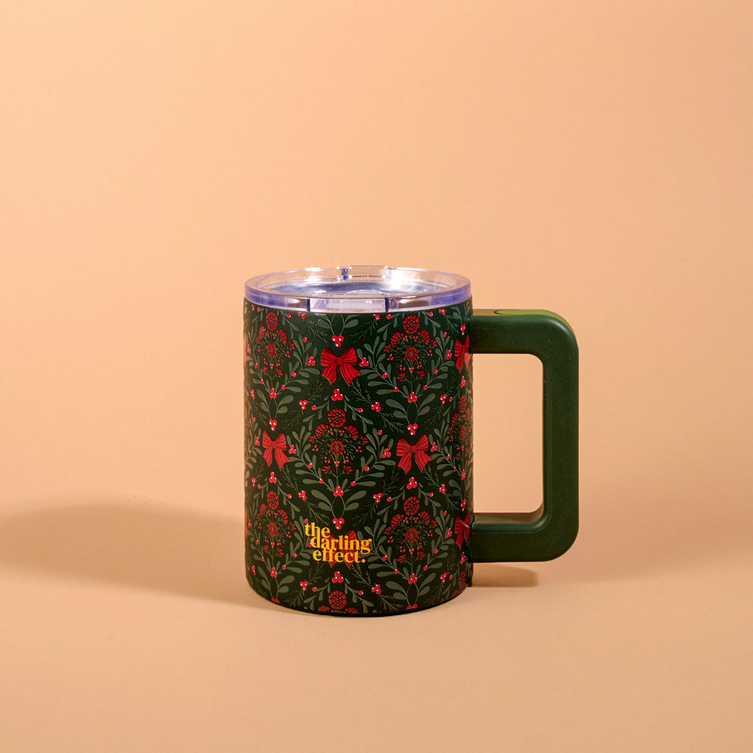 The Darling Effect 14 oz Insulated Mug featuring the festive green and red A Merry Moment floral holiday print and a clear lid.
