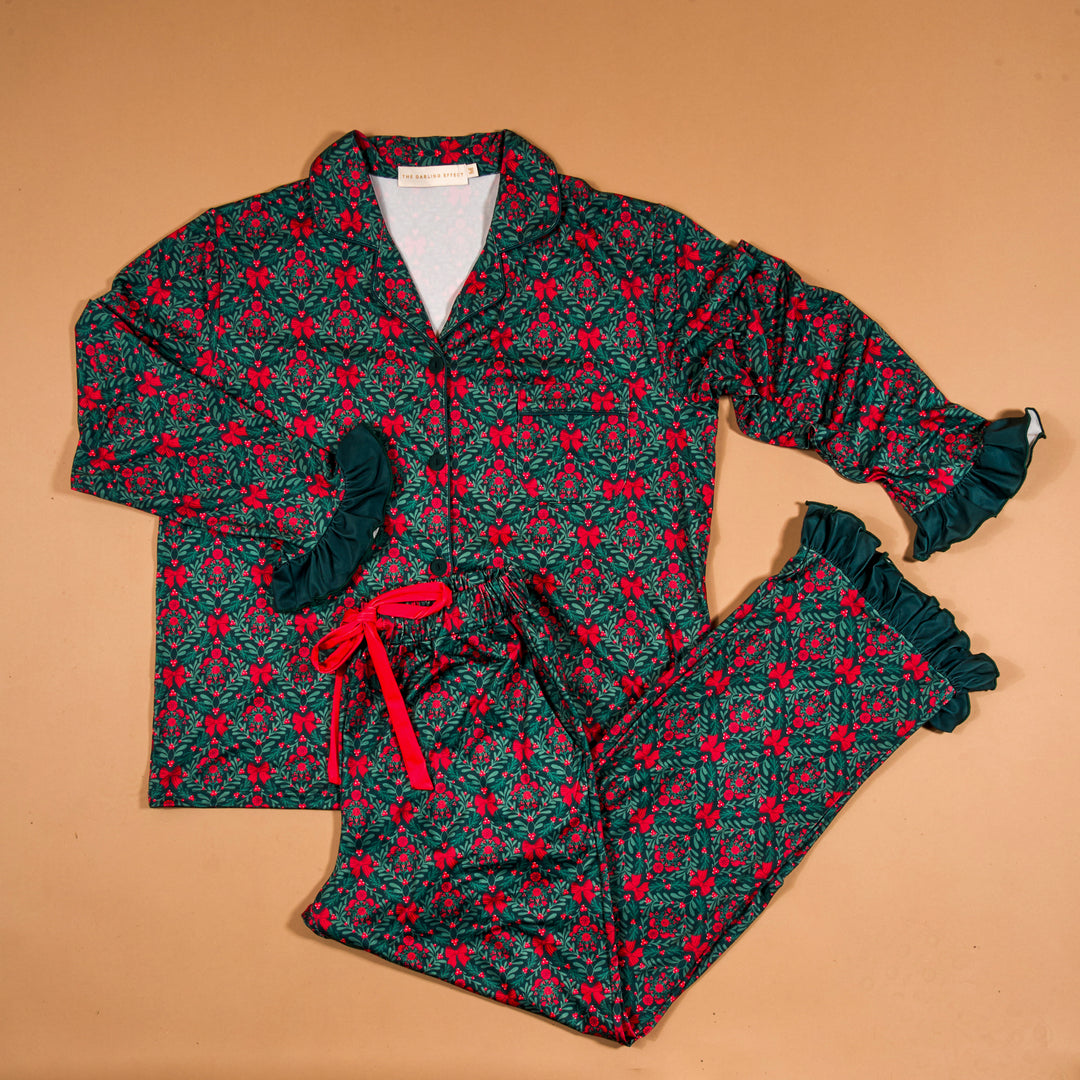 The Darling Effect Sweet Dreams two-piece pajama pants set featuring the festive green and red A Merry Moment holiday print.