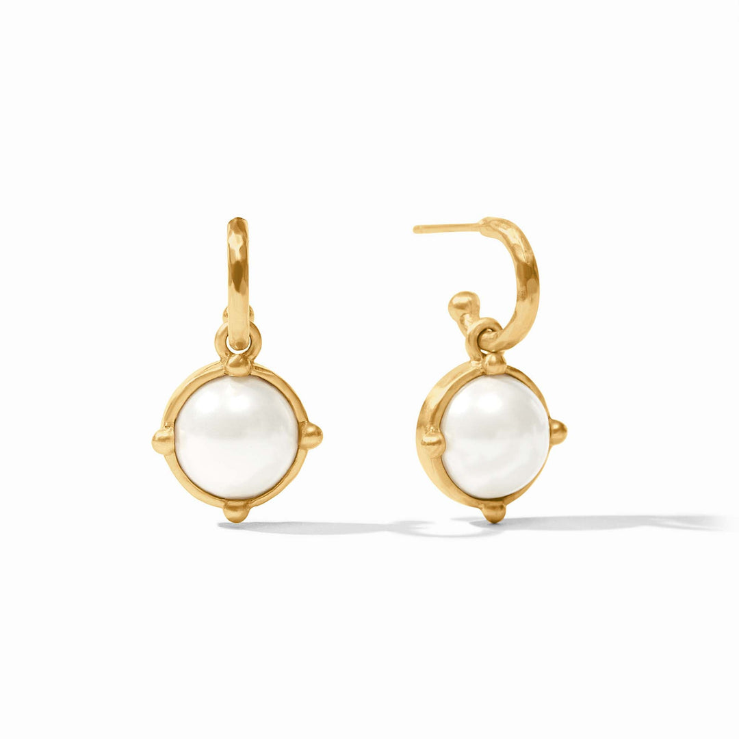 Gold earrings with white gemstones on a white background
