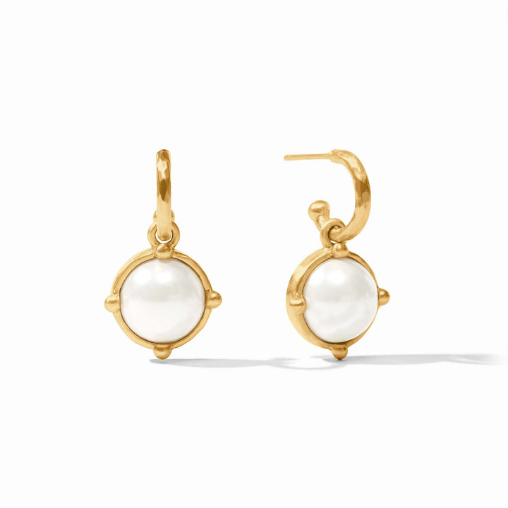Gold earrings with white gemstones on a white background