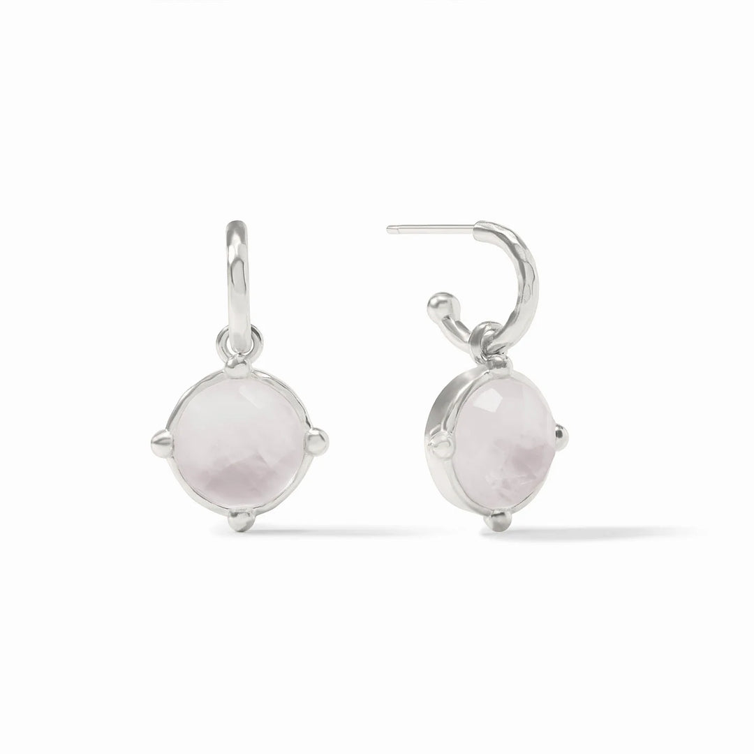 Silver earrings with round gemstones on a white background
