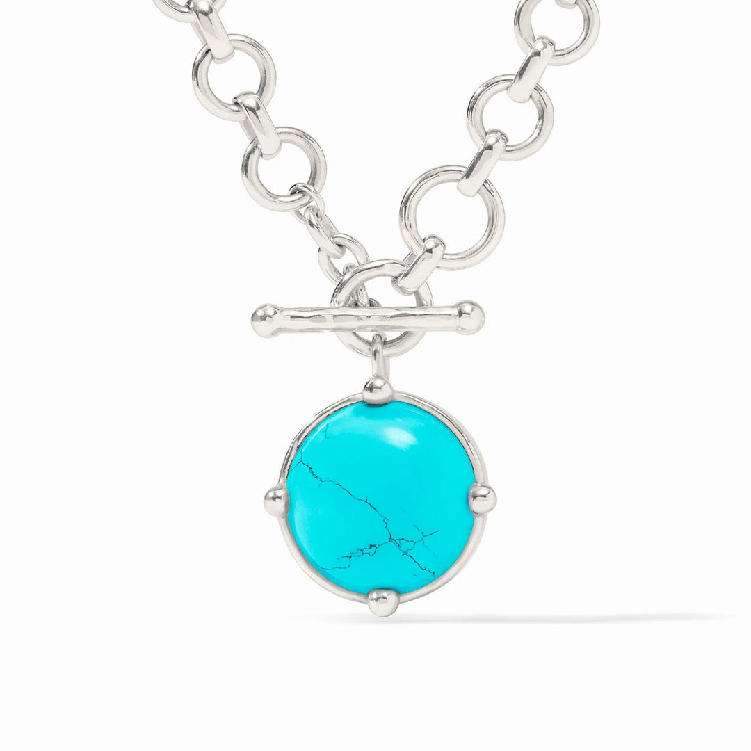 Close-up of the turquoise glass honeybee pendant and the silver toggle closure on the Demi necklace.